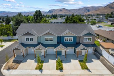 A four-home row with the valley behind